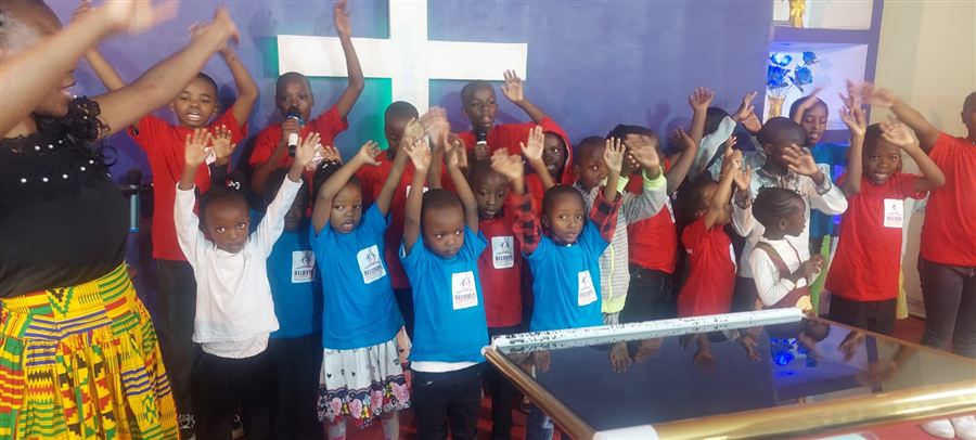 Children worshipping with raised hands at Believers Discipleship Chapel